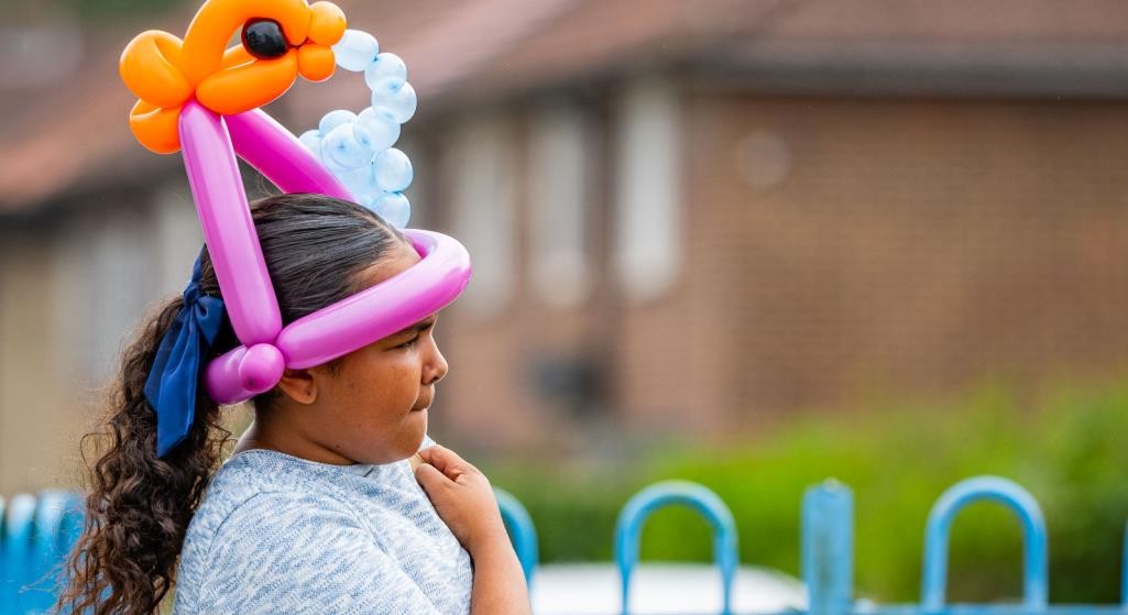 A child wearing a balloon hat at Summer Fun 2025