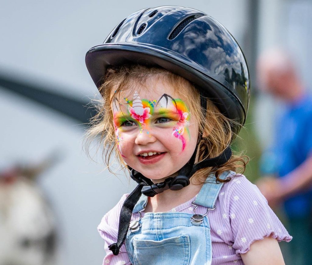 A child with butterfly face paint at Summer Fun 2025